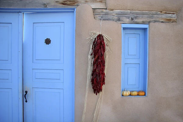 North America, USA, New Mexico. Adobe Blue Door and Hanging Chilis