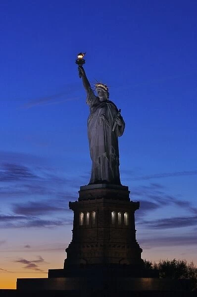 North America, USA, New York, New York City. The Statue of Liberty at sunset