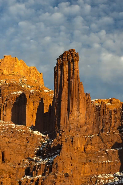 North America, USA, Utah. Fisher Towers with clouds and snow at sunset, near Castle Valley