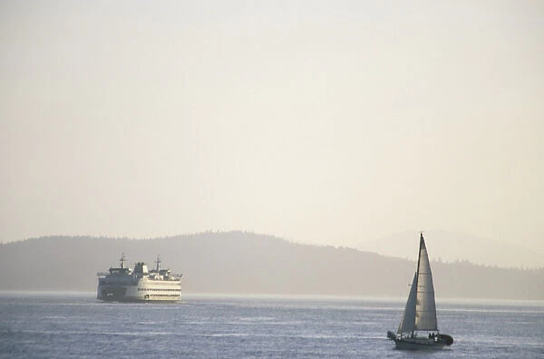 North America, USA, Washington, Seattle, Elliott Bay. Sailboat and ferry on Elliott Bay