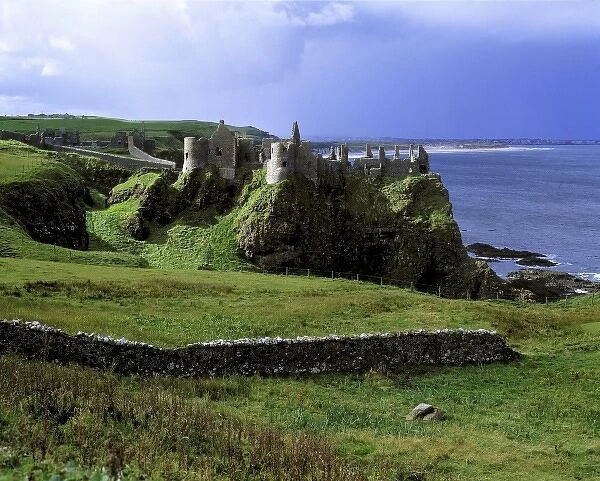 Northern Ireland, County Antrim, Dunluce Castle. Dunluce Castle rises from the emerald