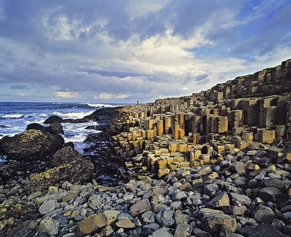 Northern Ireland, County Antrim, Giants Causeway. Visitors comb the basalt blocks