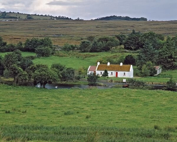 Northern Ireland, County Fermanagh, Lough Erne. A white-washed cottage with a bright