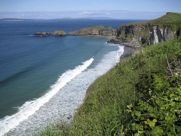 Northern Ireland, scenic coastal view along pathway out to historic Carrick-a-rede rope bridge