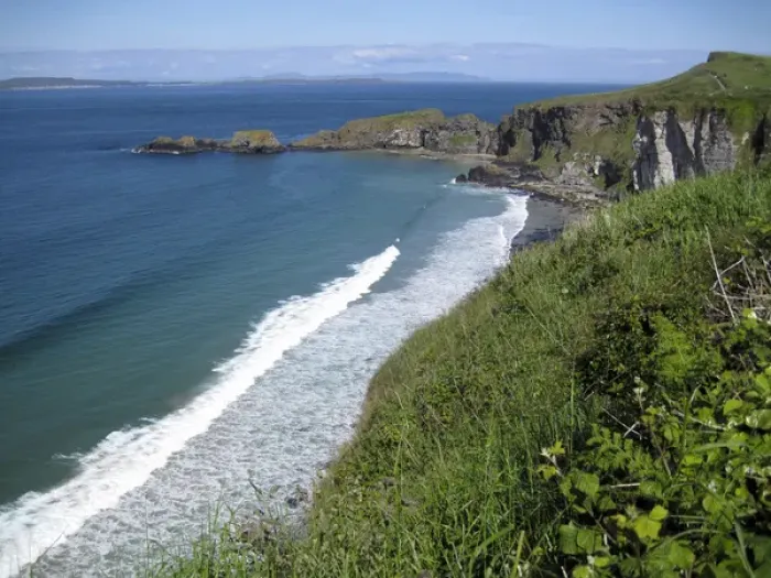 Framed Print : Northern Ireland, scenic coastal view along pathway out to historic Carrick-a-rede rope bridge