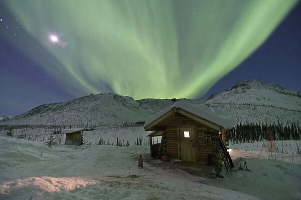 Northern Lights shimmer over the Caribou Bluff cabin in the White Mountain National