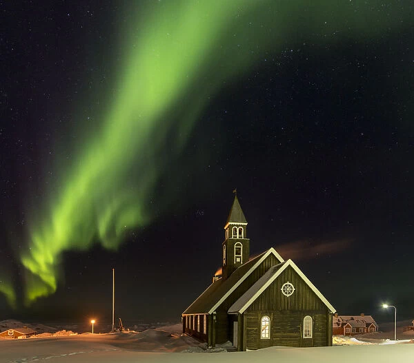 Northern Lights over the Zions Church. Ilulissat at the shore of Disko Bay, center for tourism