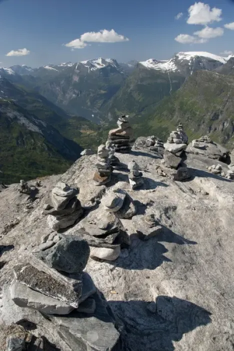 Framed Print : Norway, Geiranger. Travelers stone stacks with a view of the port of Geiranger from Mt