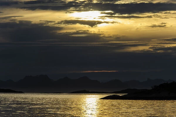 Norway, Nordland. Dramatic evening light over Vestfjorden looking towards Lofoten