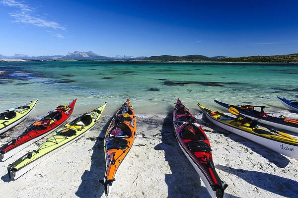 Norway, Nordland. Sea kayaks on a coral-sand beach along Vestfjorden
