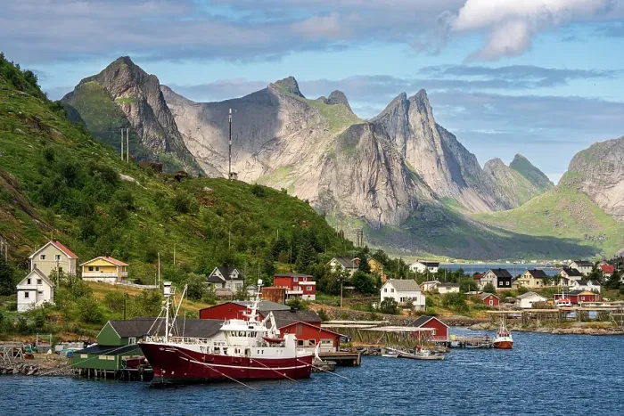 Framed Print : Norway, Reine. Fishing village houses and boats with mountain landscape. ©Don Grall  /  Jaynes Gallery  /  DanitaDelimont.com
