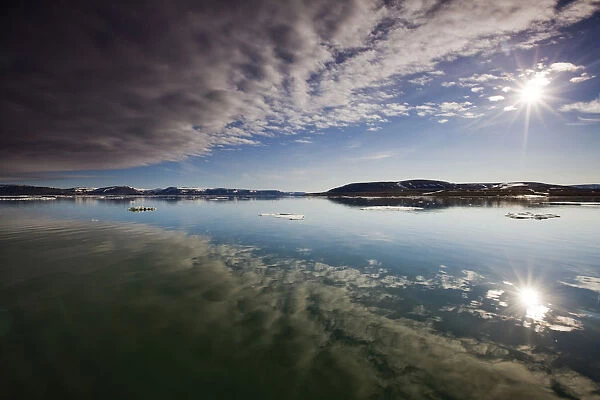 Norway, Svalbard, Edgeoya Island, Reflection of low clouds in calm sea on summer