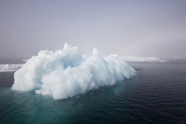 Norway, Svalbard, Iceberg floating in still sea in Storfjorden Fjord in Tusenoyane