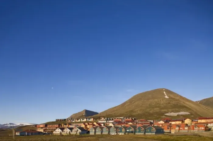 Framed Print : Norway, Svalbard, Longyearbyen, Setting midnight sun lights rows of brightly colored houses