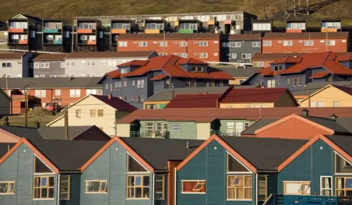 Framed Print : Norway, Svalbard, Longyearbyen, Setting midnight sun lights rows of brightly colored houses