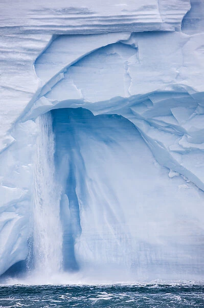 Norway, Svalbard, Nordaustlandet, Waterfall pours from ice face of Brasvellbreen