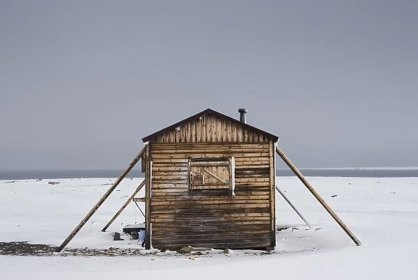 Norway, Svalbard, Nordaustlandet, Wooden trappers hut in storm during summer