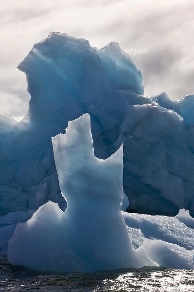 Norway, Svalbard, Nordaustlandet, Deep blue iceberg floating in Palanderbukta Bay