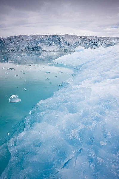 Norway, Svalbard, Spitsbergen, Blue iceberg floating near face of Lilliehook Glacier