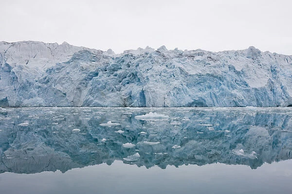 Norway, Svalbard, Spitsbergen, Ice face of Lilliehook Glacier reflected in calm