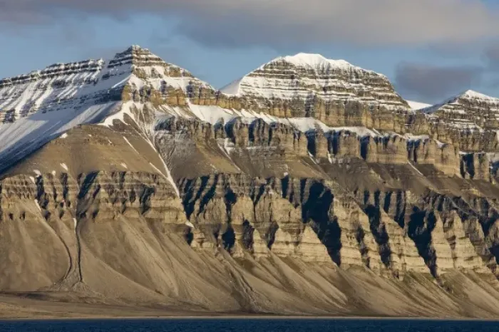 Framed Print : Norway, Svalbard, Spitsbergen Island, Setting midnight sun lights eroded cliffs