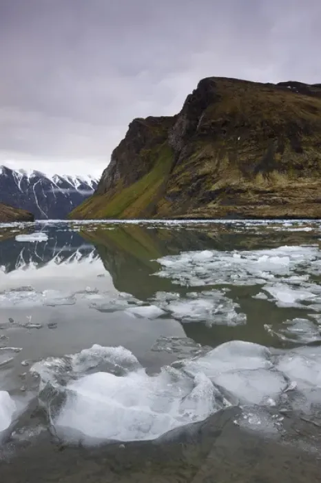 Framed Print : Norway, Svalbard, Spitsbergen, Small icebergs floating in fjord beneath mountain