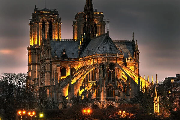 Notre Dame Cathedral and the Seine River shimmer in the Paris, France. night