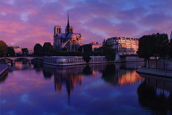 Notre Dame reflected on Seine River at sunrise, Paris, France