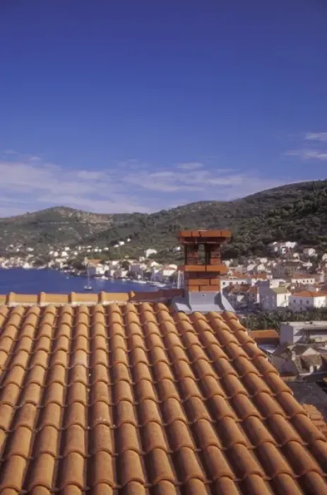Framed Print : An ochre colored roof of a house up on a hill on the western side of town provides