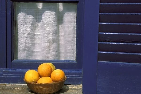 Oia, Santorini, Greece, Oranges in a basket on a windowsill in the sun