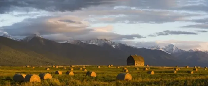 Framed Print : Old barn framed by hay bales and dramatic Mission Mountain Range in Montana