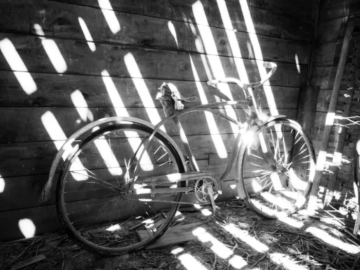 Framed Print : Old bicycle inside barn with shadows streaming