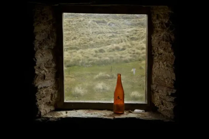 Framed Print : Old bottle in window of Potters Huts, by historic gold fields, Old Man Range, Southland Framed Print : Old bottle in window of Potters Huts, by historic gold fields, Old Man Range, Southland