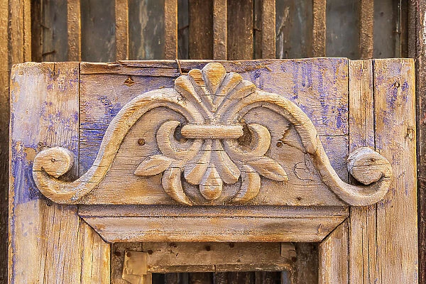 Old Cairo, Cairo, Egypt. Carved decoration on a weathered antique door