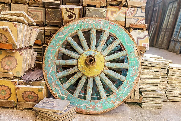 Old Cairo, Cairo, Egypt. Wooden cart wheel and floor tiles in an alley in Cairo
