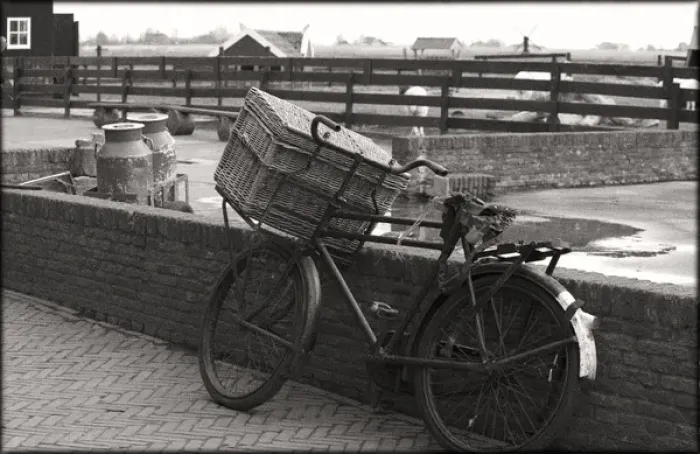 Framed Print : An old fashioned bike with basket leaning again brick wall on an old farm