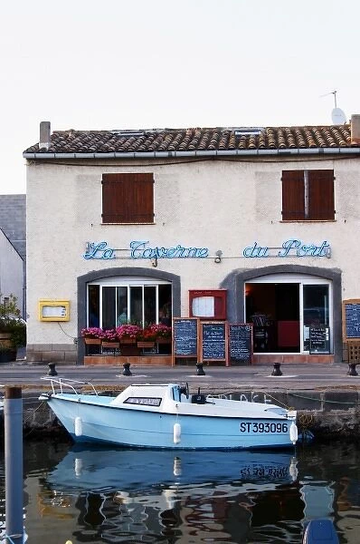 The old harbour. La Taverne du Port with many chalkboards with menus. Marseillan