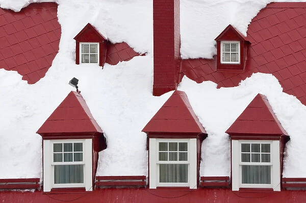 Old houses, red roof and window covered with snow, Quebec City, Canada