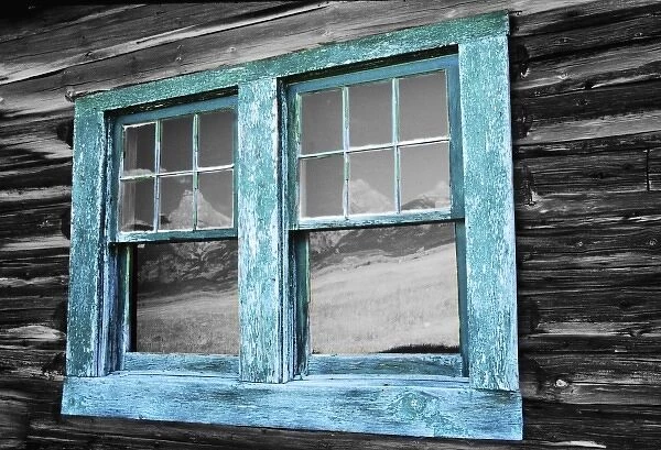 Old log cabin along Moran Row in Grand Tetons N. P. Wyoming with a reflection of
