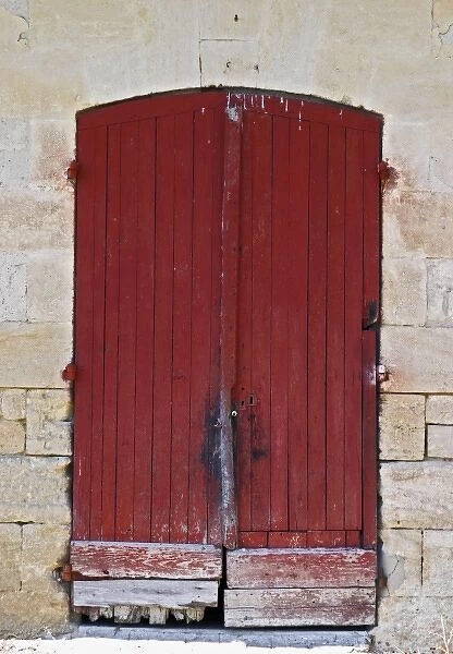 An old red wooden door on one of the winery buildings Chateau Kirwan, Cantenac Margaux
