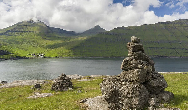 Old traditional cairns, in the background mount Slaettaratindur, the highest peak in the Faroe
