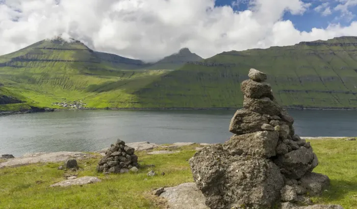 Framed Print : Old traditional cairns, in the background mount Slaettaratindur, the highest peak in the Faroe