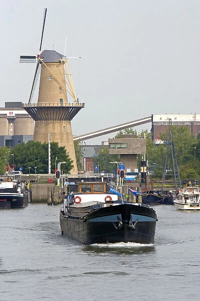 Old windmill and boats in the harbor at Rotterdam, Netherlands