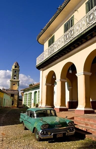 Old worn 1958 Classic Chevy on cobblestone street in center square of Trinidad Cuba