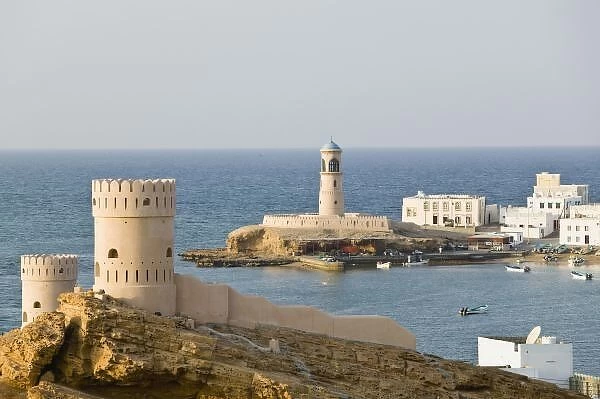Oman, Sharqiya Region, Sur. Towers of Al Ayajh Fort  /  Sur Bay  /  Late Afternoon