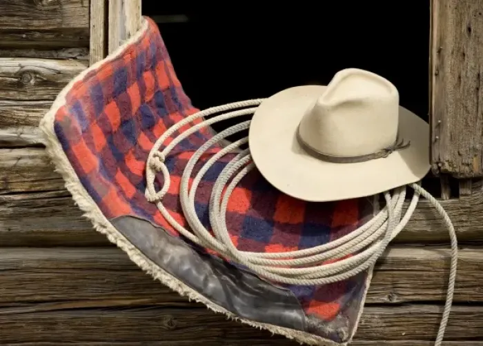 Framed Print : Oregon, Seneca, Ponderosa Ranch. Cowboy hat, rope and horse blanket sitting on