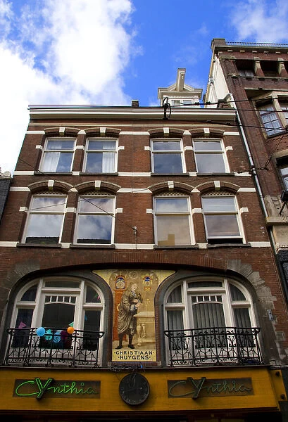 An ornate building decorated with a mosaic of tiles of Christiaan Huygens, the Dutch