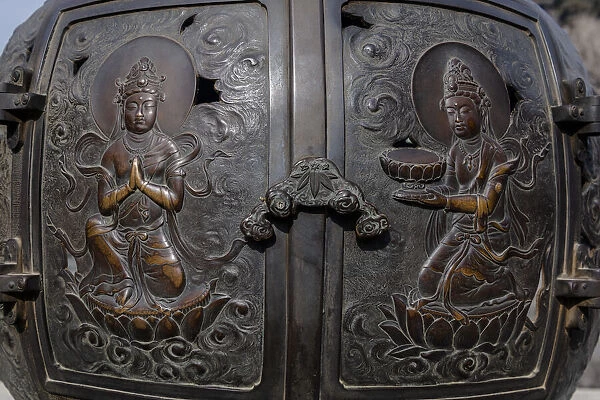 The ornate, engraved bronze doors to the outdoor incense burner of the Daibutsu, Kamakura