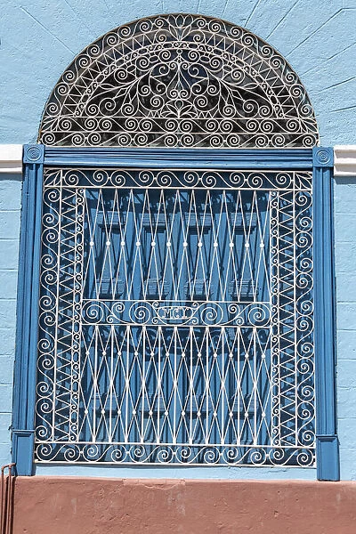 Ornate wrought iron covering on blue wooden window shutters, Trinidad, Cuba