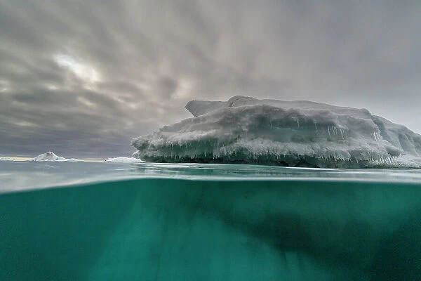 An over-under view of an iceberg. Vibebukta, Austfonna, Svalbard, Norway